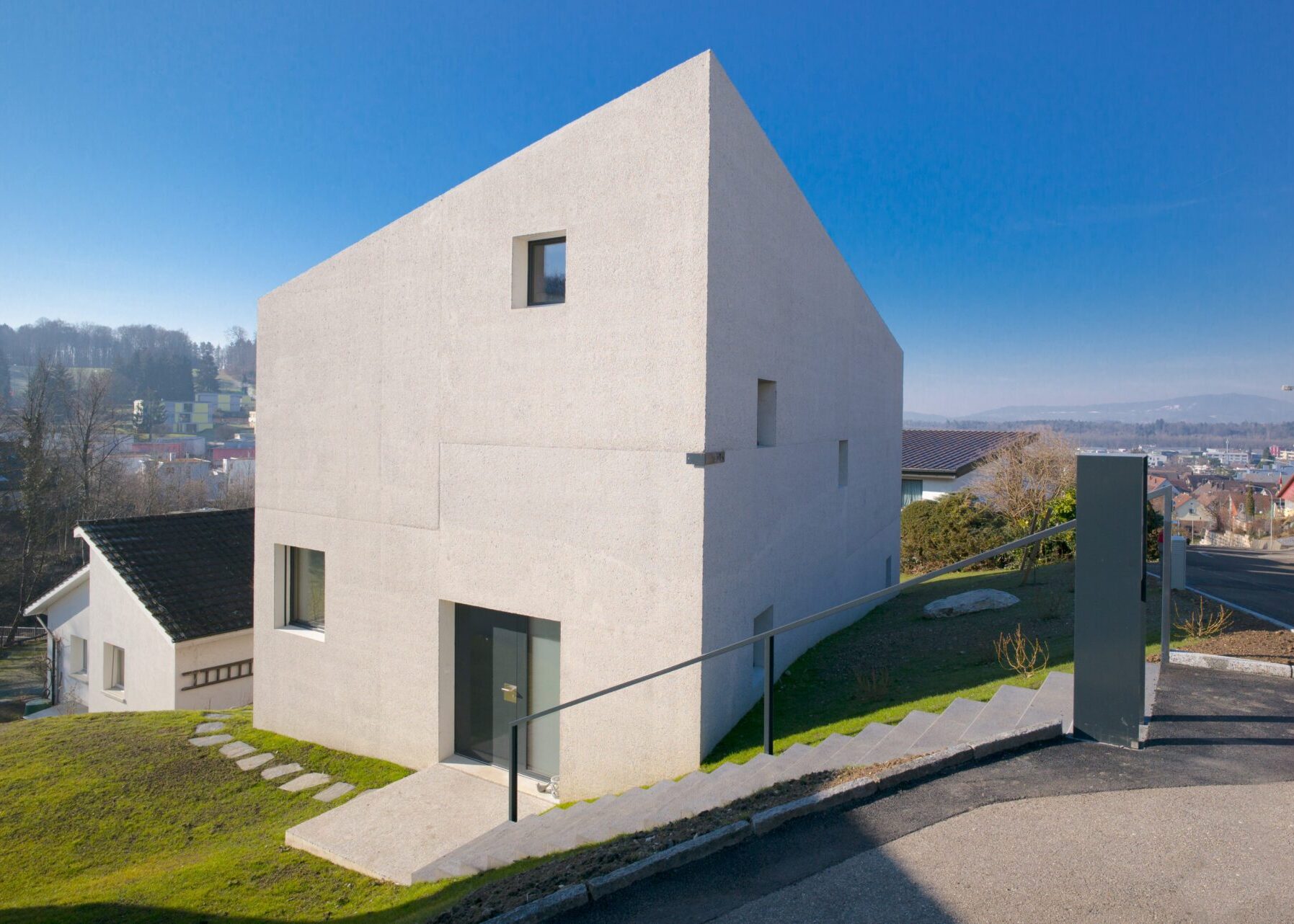Strassenfassade eines modernen Einfamilienhauses nahe Bülach mit grossen Fensteröffnungen - Architektur Hansjörg Betschart